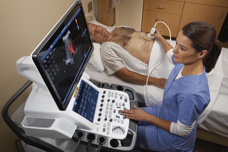  A sonographer performs an abdominal ultrasound exam with GE's Vivid E95 system