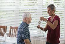 The patient’s wife changes the Optune array. Clinical trials indicate that the electrical fields emitted by Optune have the potential to lengthen the lives of patients with glioblastoma.